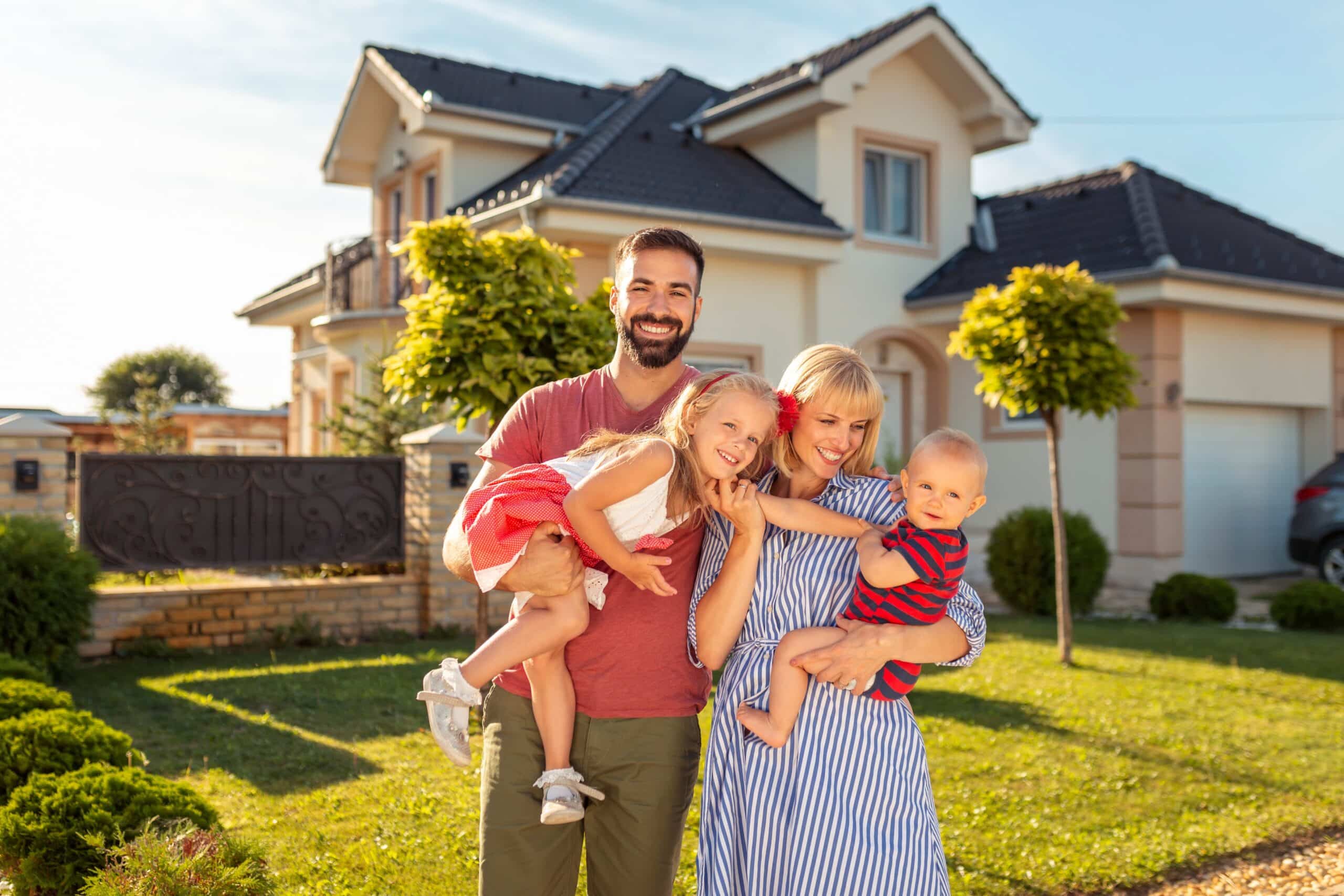 Family standing in front of their new house