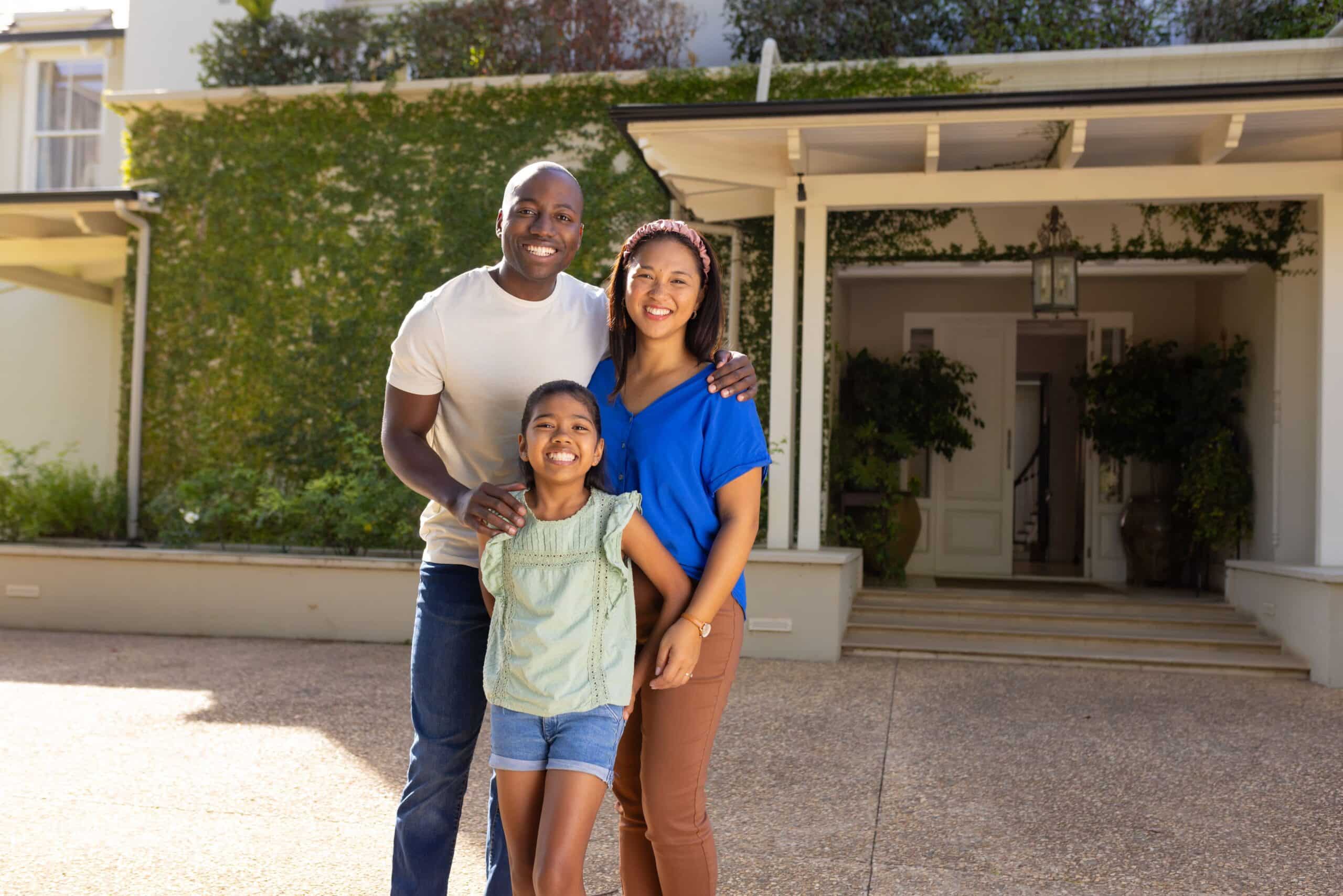 Smiling Family of Three with Daughter standing